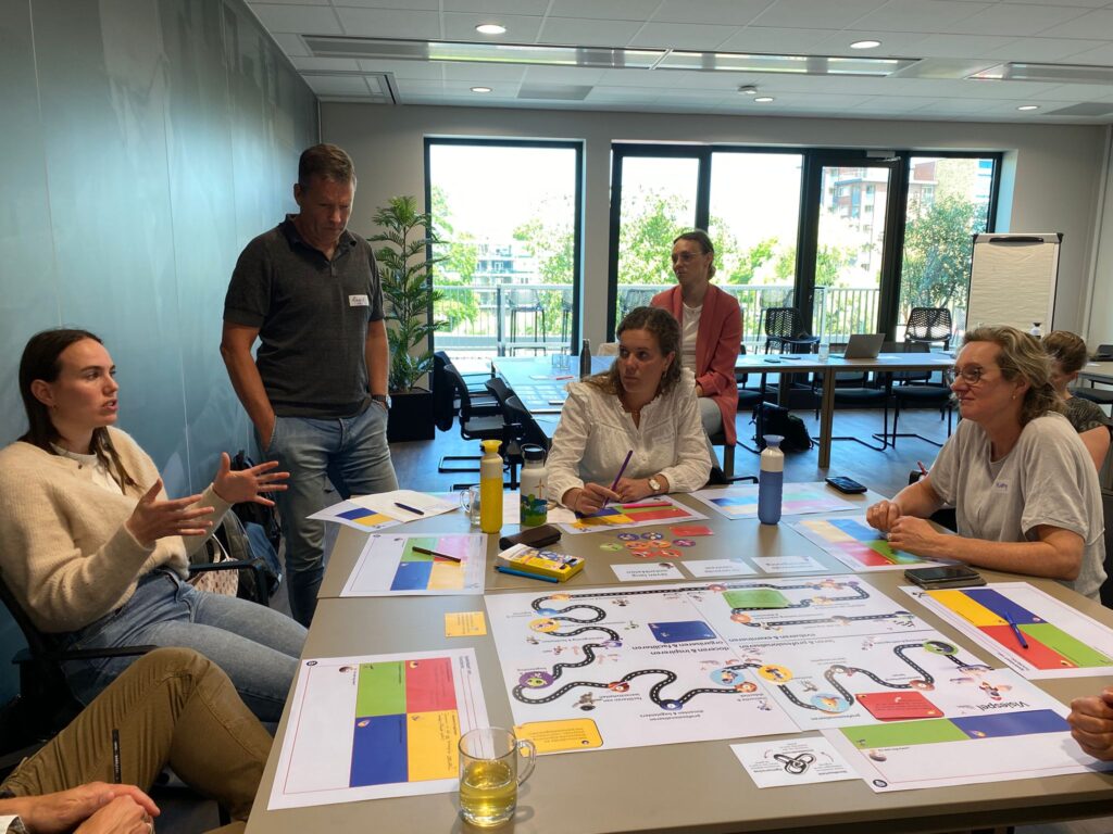 Mensen in gesprek tijdens bijeenkomst over het programma Onderwijs Onderweg.